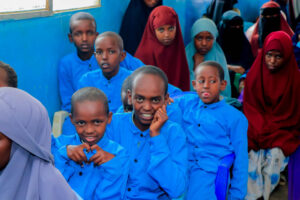 Ethiopian school kids, one of them is making a heart with his hands