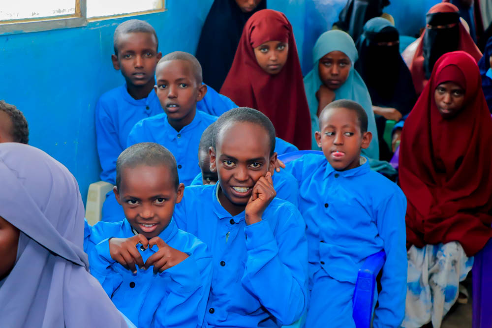 Ethiopian school kids, one of them is making a heart with his hands